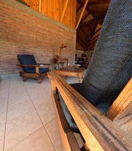eine Holzbank in einem Zimmer mit Stuhl in der Unterkunft Hostería Altas Cumbres in El Chalten + 15 Fotos