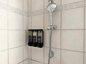 a shower in a bathroom with a shower head at Zentrale Oase, Ski, Berge Spass, 45m2, für 2P - C8 in St. Moritz +31 photos