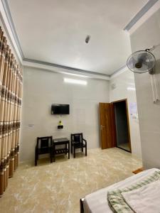 a room with two chairs and a table and a tv at Thiên Tân Motel 2 in Quang Ngai +14 photos