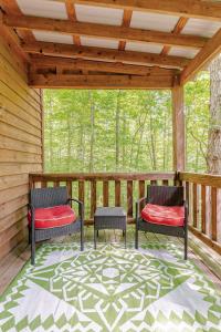 a screened porch with two chairs and a rug at Rustic Cabin on 28-Acre Property in the Foothills of the Blue Ridge Mountains in Elkin