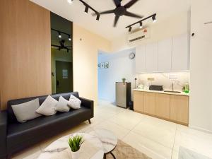 a living room with a couch and a kitchen at Bay Premier Suites by SSVC in Kota Kinabalu