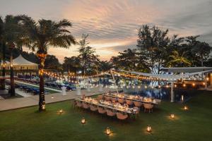a wedding reception at a resort with tables and lights at Hyatt Regency Phuket Resort in Kamala Beach +137 photos
