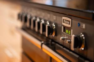 a close up of the control panel of an oven at ARCTIC HOMES - The Spacious Villa in Tromsø