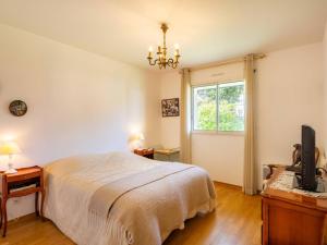 a bedroom with a bed and a tv and a window at Carnac - Maison d'Architecte 7 Pièces 165m² - Wifi - FR-1-477-270 in Carnac