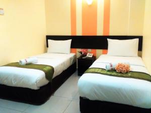Postel nebo postele na pokoji v ubytování Sun Inns Hotel Puchong