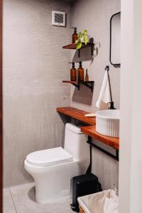 a bathroom with a toilet and a sink at Desierto de Acero Containers in San José del Cabo