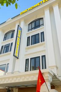 a large white building with a sign on it at Gia Hưng Khang Hometel in Ha Long