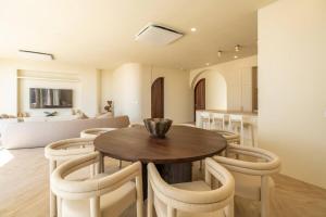 a dining room with a wooden table and chairs at Villa Imani 4 bedroom villa in dreamland with ocean views in Bingin Beach