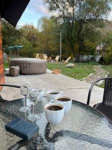 a glass table with wine glasses and a bowl of coffee at Gamma house in Verin Ptghni