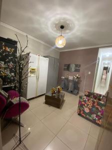 a living room with a refrigerator and a couch at Eds pousada in Juazeiro do Norte