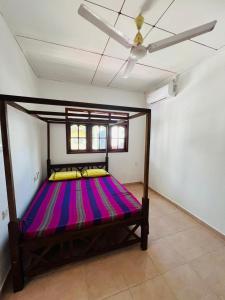 a large bed in a room with a ceiling at Ranathunga Guest House in Ginimellagaha West +8 photos