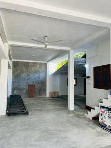 a living room with a ceiling fan in a house at Ranathunga Guest House in Ginimellagaha West