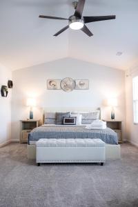 a white bedroom with a bed and a ceiling fan at The Beautiful 31 in Port Wentworth +119 photos