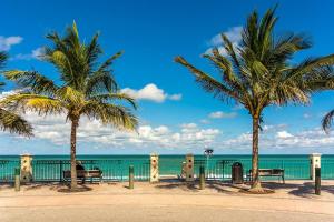 a person sitting on a bench next to the ocean at 140 Ocean Estates Dr in Lakewood Park