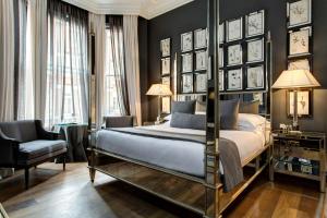 a bedroom with a four poster bed and a chair at The Franklin London - Starhotels Collezione in London +44 photos