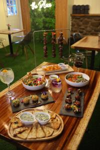 a wooden table topped with different types of food at Boquete Firefly Inn in Boquete
