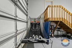 a batting cage with balls in it next to a stairs at Lake Geneva Family House Pool Table Fireplace and Sleeps 10 in Lake Como +32 photos