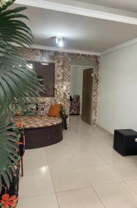 a living room with a couch and a stone wall at Eds pousada in Juazeiro do Norte