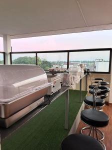 a room with a row of beds and stools at Goodtimeบึงโขงหลง in Ban Don Klang