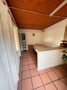 a small room with a bed and a tiled floor at Monoambiente Caracol chico in Aguas Dulces +23 photos