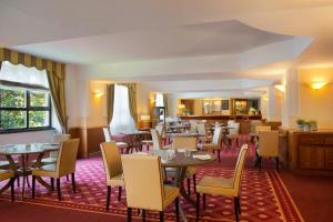 a restaurant with tables and chairs in a room at Starhotels Business Palace in Milan
