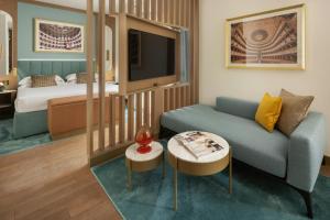 a living room with a couch and a bed at Teatro Luxury Apartments Firenze - Starhotels Collezione in Florence