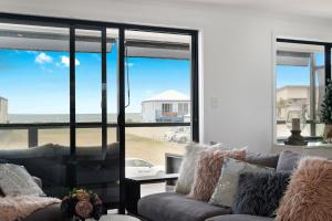 a living room with a couch and a view of the beach at 32 Hargreaves-Linen Included-Pets Negotiable-Wi-Fi in Middleton +45 photos