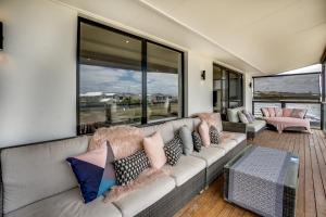 a living room with a couch and a large window at 32 Hargreaves-Linen Included-Pets Negotiable-Wi-Fi in Middleton