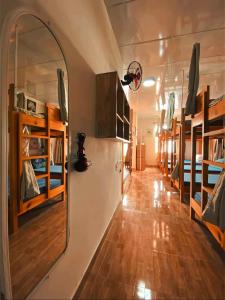 a room with a hallway with many bunk beds at Dalat Peace Backpackers Hostel in Da Lat +42 photos