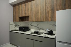 a kitchen with a counter top and a refrigerator at Апарт-отель Abyroy in Rudny