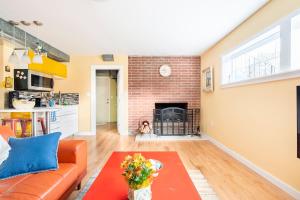 a living room with a couch and a fireplace at Fresh Space Quiet Air Studio in Mercer Island