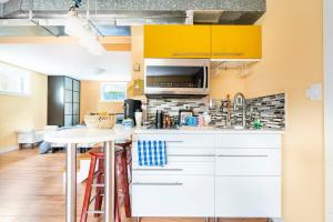 a kitchen with white cabinets and a white counter top at Fresh Space Quiet Air Studio in Mercer Island +14 photos