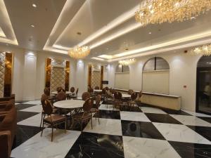 a meeting room with tables and chairs and a chalkboard at B Dot in Gaushala