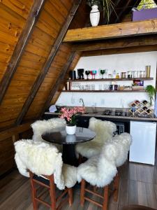 a kitchen with chairs and a table in a attic at A-Frame da Lagoa in Imaruí +27 photos