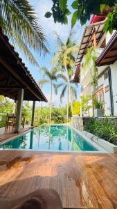 a swimming pool in front of a house at Brown Birds Villa in Tangalle