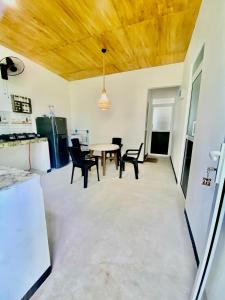 a kitchen and dining room with a table and chairs at Cinnamon garden villa in Weligama