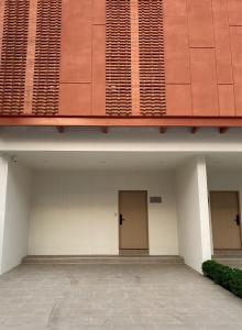 a building with two doors on the side of it at Swan, Private Pool Villa Bangsaen in Ban Thai Don (1)