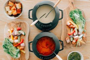 a table topped with bowls of food and a drink at BOTANICAL POOL CLUB in Kyonan