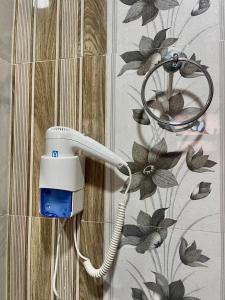 a phone is hanging on a wall in a bathroom at Jabal Shams Villa in Sa‘ab Banī Khamīs