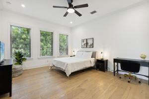 a white bedroom with a bed and a ceiling fan at 132 Ocean Estates Dr in Lakewood Park +36 photos