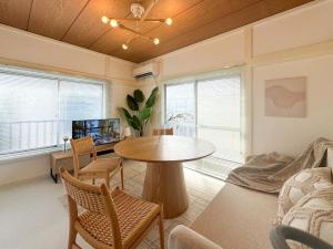 a living room with a table and chairs and a tv at -浮間舟渡 菖Iris-Entire 2nd floor in Tokyo
