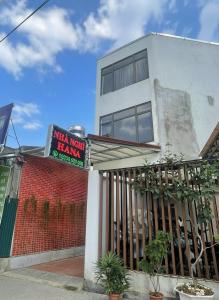 a building with a sign that reads what i wont harm at Hana House in Kỳ Lừa