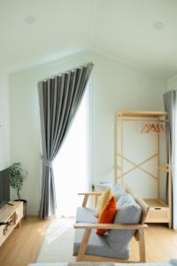 a room with a couch and a large window at Waveway bangsaen 1 in Ban Thai Don (2) +3 photos