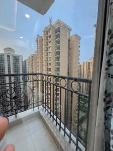 a balcony with a view of some tall buildings at Hideaway Nest in Ghaziabad