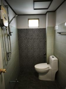 a small bathroom with a toilet and a window at StayStable Guest House in Ko Lanta Yai +24 photos