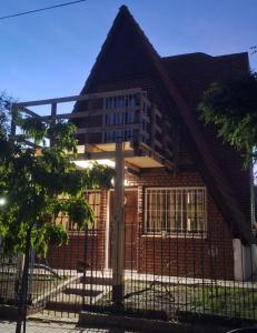 a house with a fence in front of it at Velero de Mar in Las Grutas