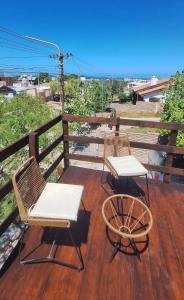 two chairs and a table on a deck at Velero de Mar in Las Grutas