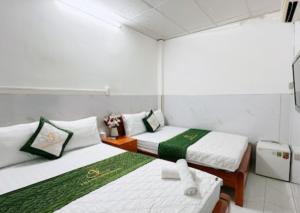 Postel nebo postele na pokoji v ubytování Thanh Long Hotel Hồ Chí Minh