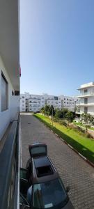 a car parked on a street next to a building at appartement sable dor in Mohammedia