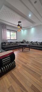 a room with couches and tables in a room at appartement sable dor in Mohammedia